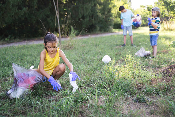 istock Kids Joyfully Pick Up Trash to Save the Planet 2211261712