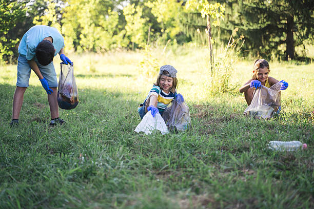 istock Kids Collecting Trash: Building a Better Future Together 2211261718