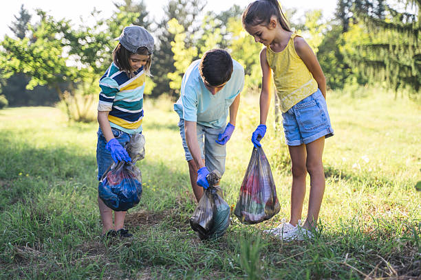 istock Three Children Participating in a Cleanup Effort 2211261729