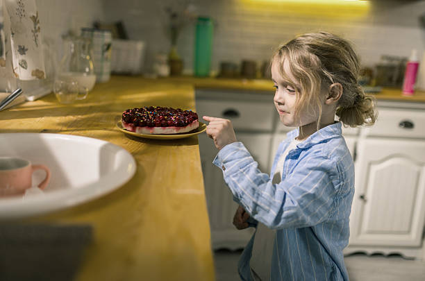 Asian young girl child eating strawberry cake in the cafe.