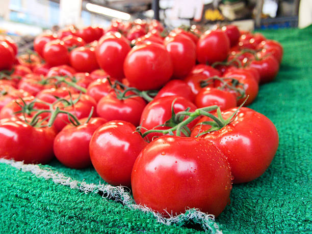 Tomatoes on sale at a market stall