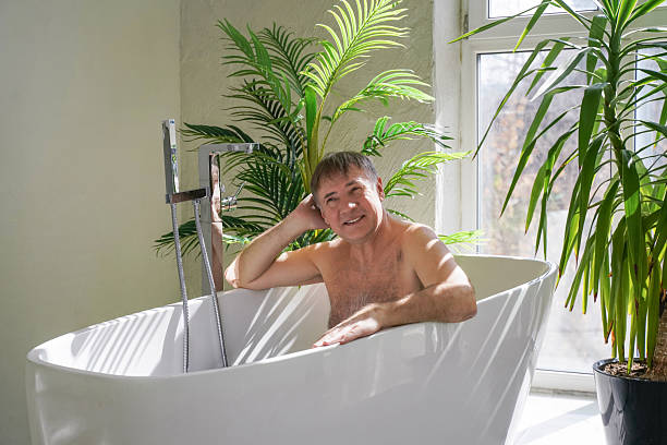 istock Portrait of handsome middle aged man taking bathtub 2211264778