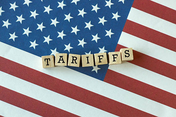 istock TARIFFS word on wooden blocks over United States flag. 2211266617