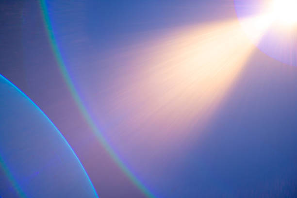 A vibrant lens flare casts soft light and colorful gradients against a tranquil background, illuminating the scene with a magical glow during the golden hour