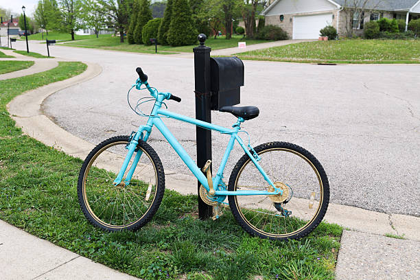 An Old Bicycle In A Sidewalk In A Neighborhood