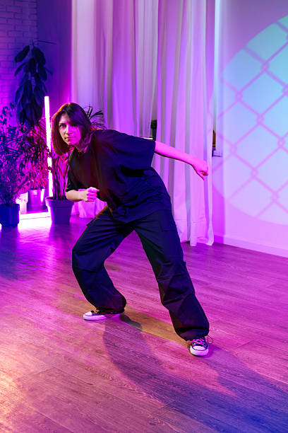 istock Dancer showcases expressive movement in a vibrant studio with neon lighting during a creative session 2211273557