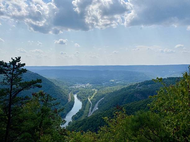 istock Scenic valley with river and forested hills. 2211273944