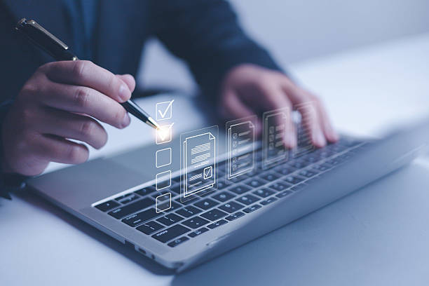 istock Business performance checklist concept, Businessman using laptop take an assessment, An businessman checklist online survey filling form list options business employee security procedures. 2211274449