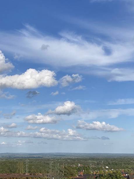 istock Blue sky with white clouds over an open vast countryside landscape. 2211275409