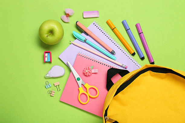 istock Backpack, different school stationery and apple on light green background, flat lay 2211278515