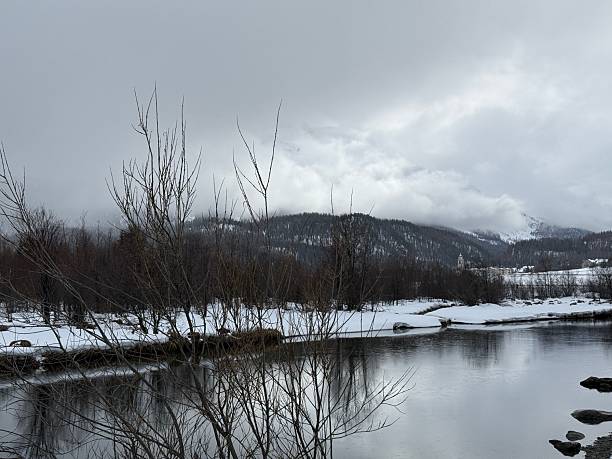 istock Serene winter landscape with mountains and river 2211279132