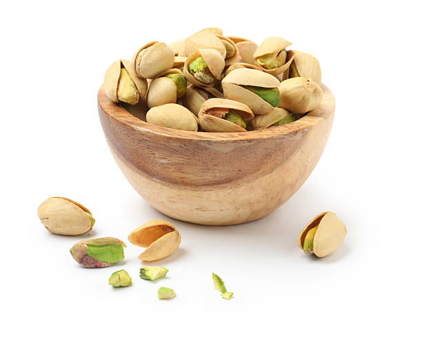 istock Tasty pistachio nuts in bowl isolated on white 2211280271