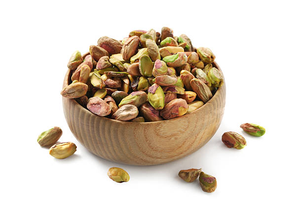 istock Peeled pistachio nuts in bowl isolated on white 2211280322