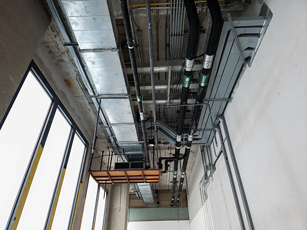 istock ceiling mechanical and piping system installation in unfinished commercial building interior 2211281075