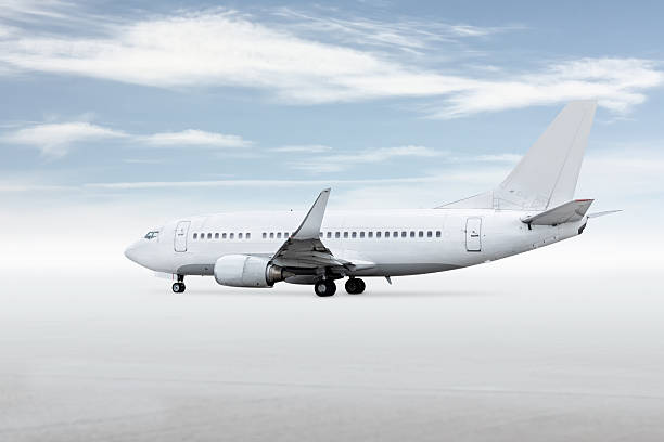 istock White passenger jetliner isolated on bright background with sky 2211282072