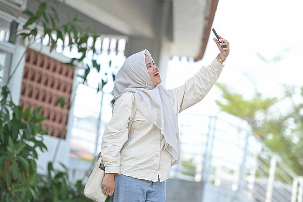 istock Asian Woman Taking Selfie with Mobile Phone Camera 2211287148