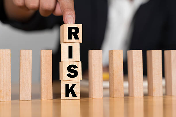 istock Businessman Stop Domino Effect. Risk Management and Insurance Concept. 2211287178