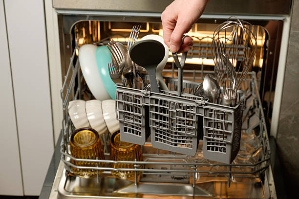 istock Dishwasher loaded with silverware and utensils ready for a thorough clean 2211288070