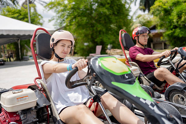 istock couple racing on go-cart 2211288084
