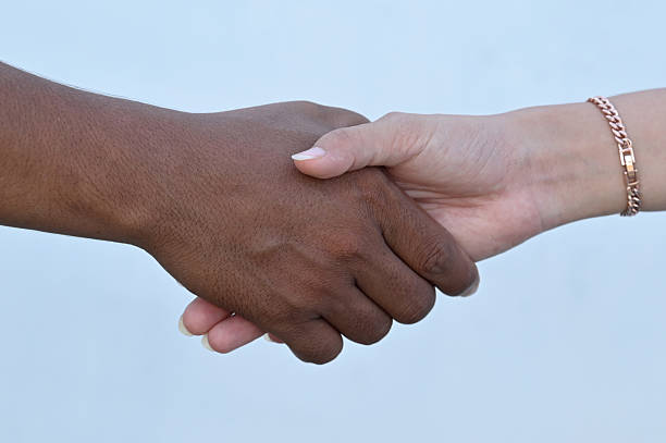 White friend shaking hands with black friend