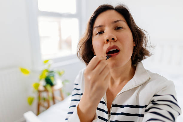 istock Woman applying make-up and recording vlog 2211291196
