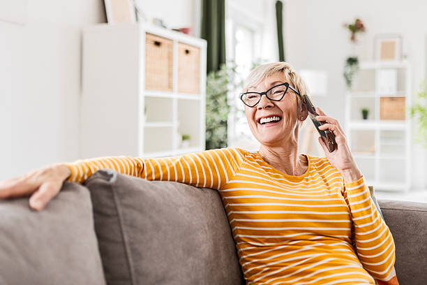 istock Elderly Woman Enjoying Her Smartphone on the Couch 2211291246