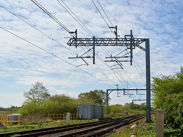 istock Railroad overhead electric power supply lines above train track 2211291294