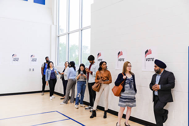 istock Multiracial People Voting in Line at Polling Place 2211291626
