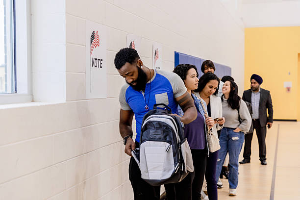 istock Multiracial People Voting in Line at Polling Place 2211291635