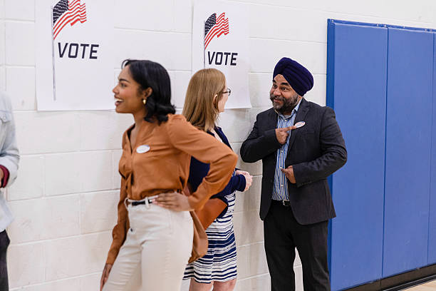 istock Voting Day: Happy and Confident People at the Polling Place 2211291641