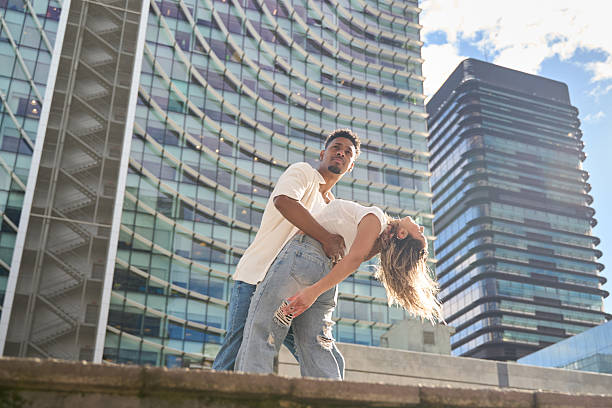 istock Dancers performing in urban landscape with modern buildings 2211293413