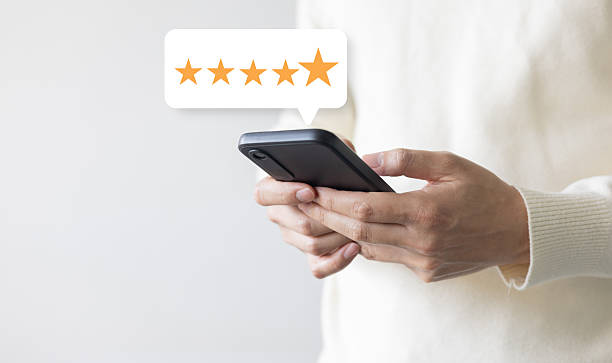 istock close up on customer man hand check on gold five star rating feedback icon and press level best rank  for give score point to review the service business concept 2211294406