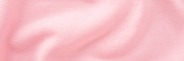istock Light pastel pink wavy soft knitted fabric background. Closeup. Wide banner. Top down view. 2211294700
