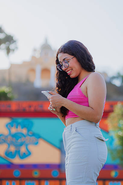 istock Young Mexican tourist checking phone at Cholula archaeological site 2211298209