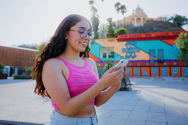 istock Young Mexican tourist checking phone at Cholula archaeological site 2211298337