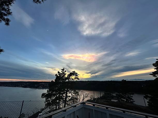 istock Sunset over lake with silhouetted trees. 2211301324