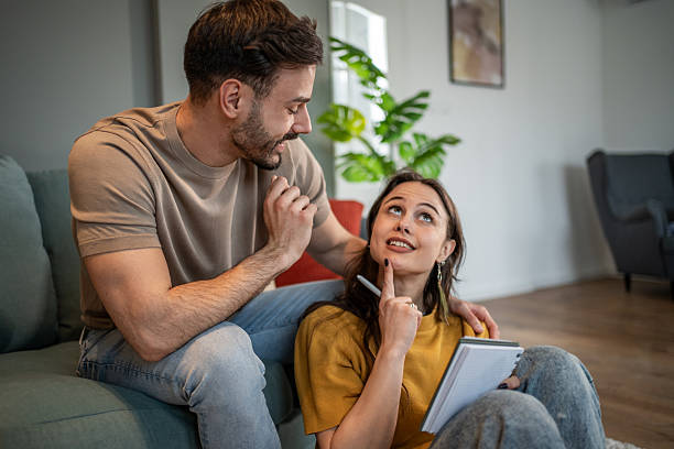 istock Young couple brainstorming ideas together at home 2211301394