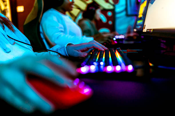 istock Pro gamer playing on a colorful backlit keyboard and mouse 2211303395