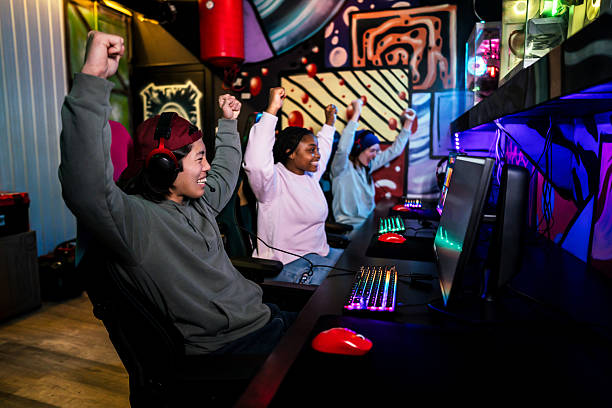 istock Gamers celebrating victory in internet cafe 2211304425