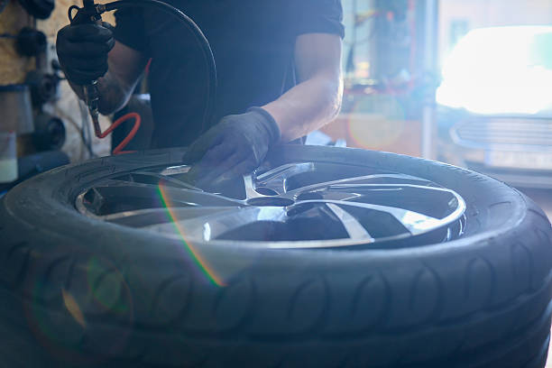 istock Mechanic pumping a wheel, close-up 2211304516