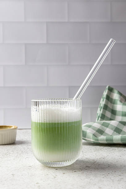 Refreshing iced matcha latte in a stylish glass with a reusable straw