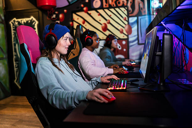 istock Gamers playing on colorful rgb computers in gaming room 2211304846