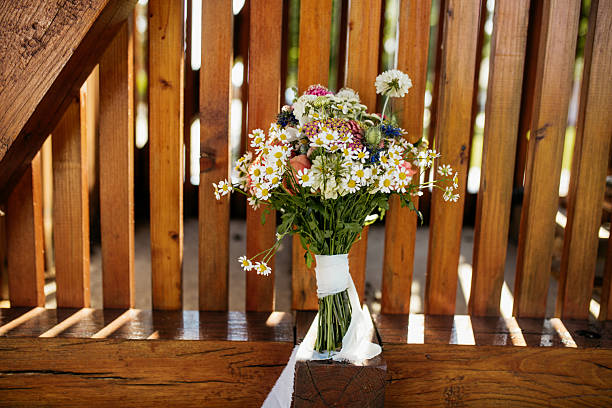 Beautiful flowers outdoor leaned on a wooden fence