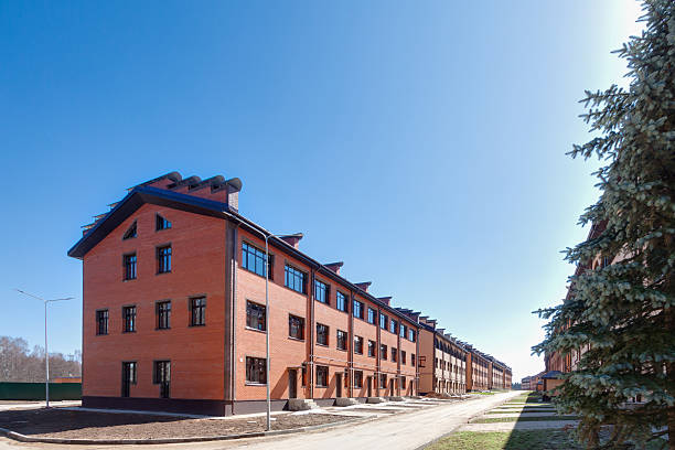 istock Row of new red brick townhouses under construction 2211309792