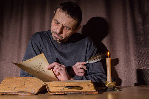 istock A European man reads an ancient book 2211311163