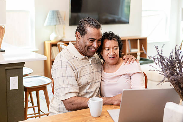 istock Happy Mature Couple Using Laptop Together at Home 2211314252