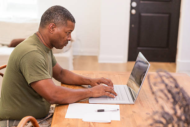 istock African-American Man Using Laptop, Working From Home Office 2211314294