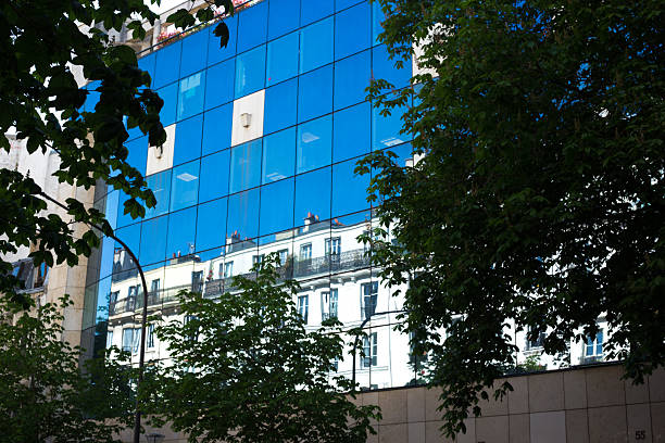 Paris, France: Modern Glass Building Reflects Traditional Old Building in the 12th arrondissement.