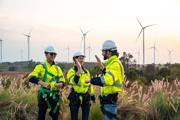 istock Technician and Engineer Working on a Windmill Turbine in the Field, Harnessing Renewable Energy for Sustainable Power Generation, Using Advanced Technology and Innovation to Support the Environmental 2211315599
