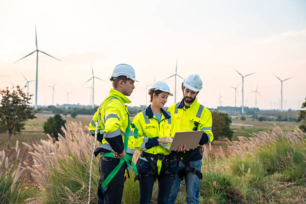 istock Technician and Engineer Working on a Windmill Turbine in the Field, Harnessing Renewable Energy for Sustainable Power Generation, Using Advanced Technology and Innovation to Support the Environmental 2211315620